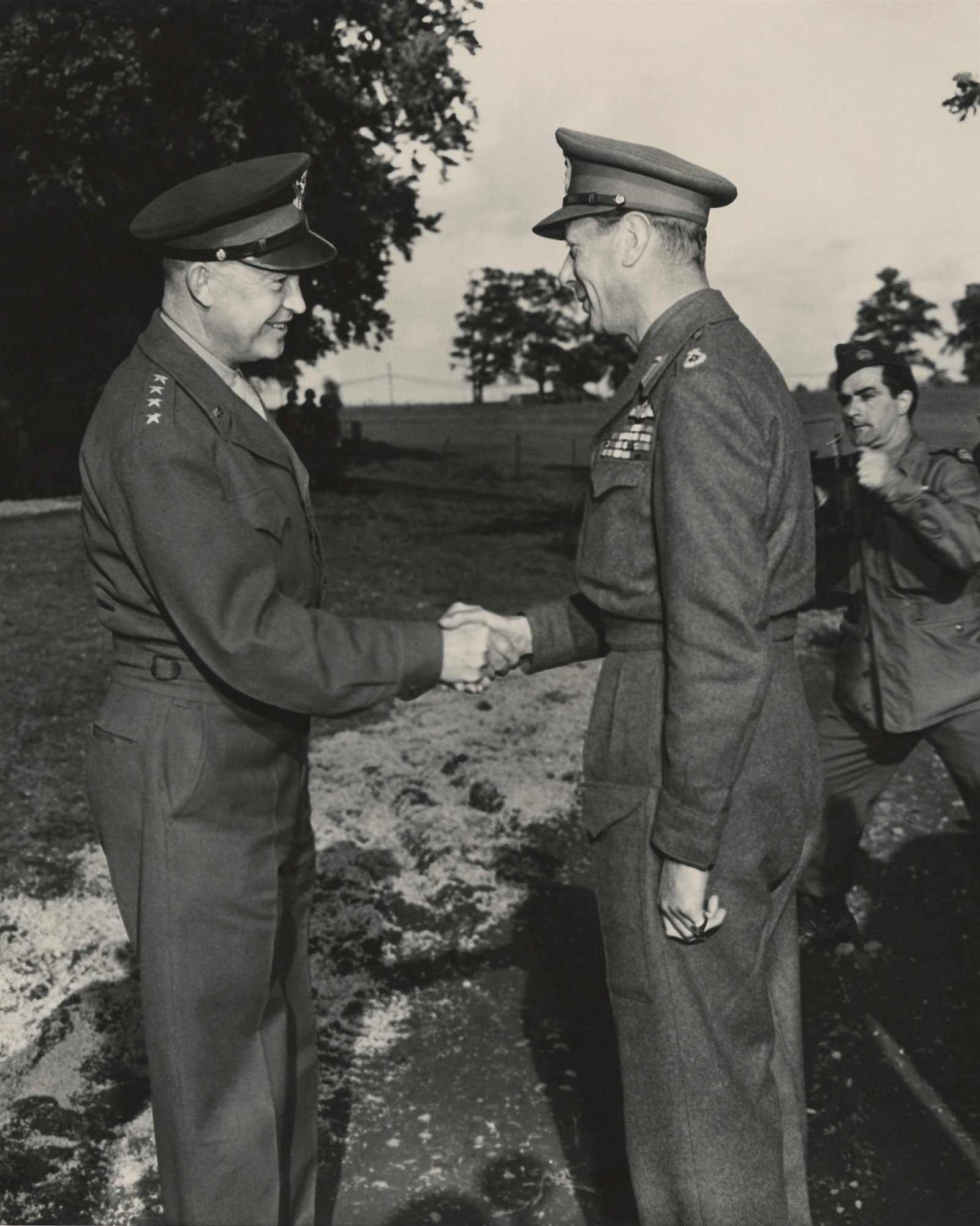 General Eisenhower shaking hands with King George VI while Miller's founder Bill Miller steps into position with his camera